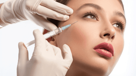 a woman receives an injection of Azzalure in the area around the eyes