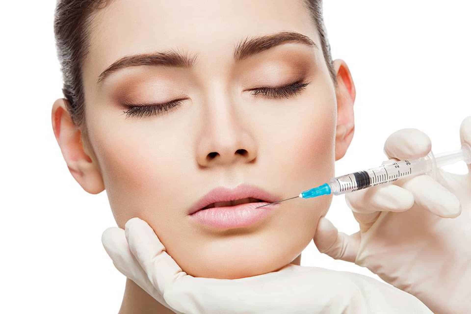 a woman receives a Hyaluronidase injection in the lower lip