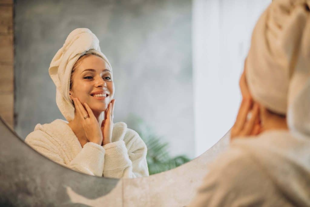 young woman smiling in a mirror