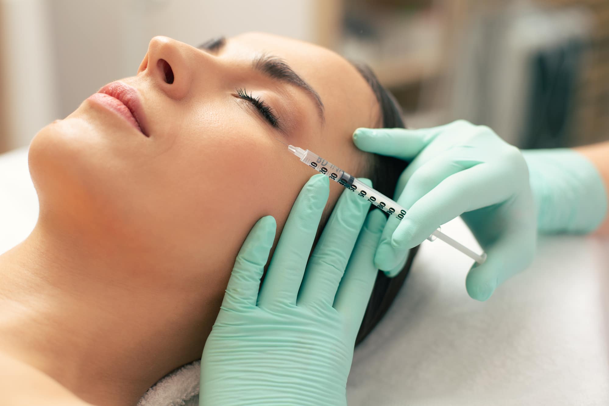 woman getting dermal filler under eye