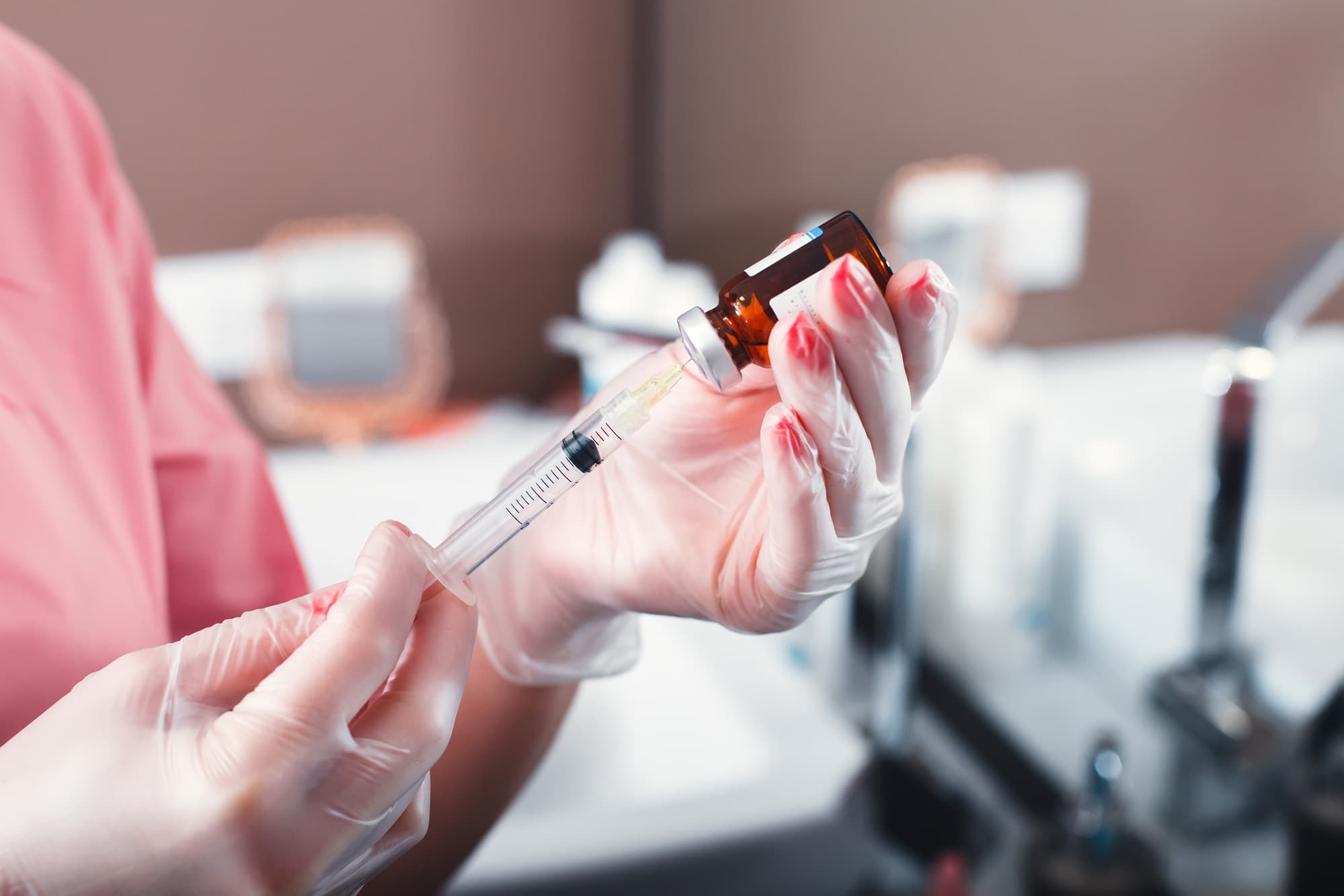 medical professional using a syringe