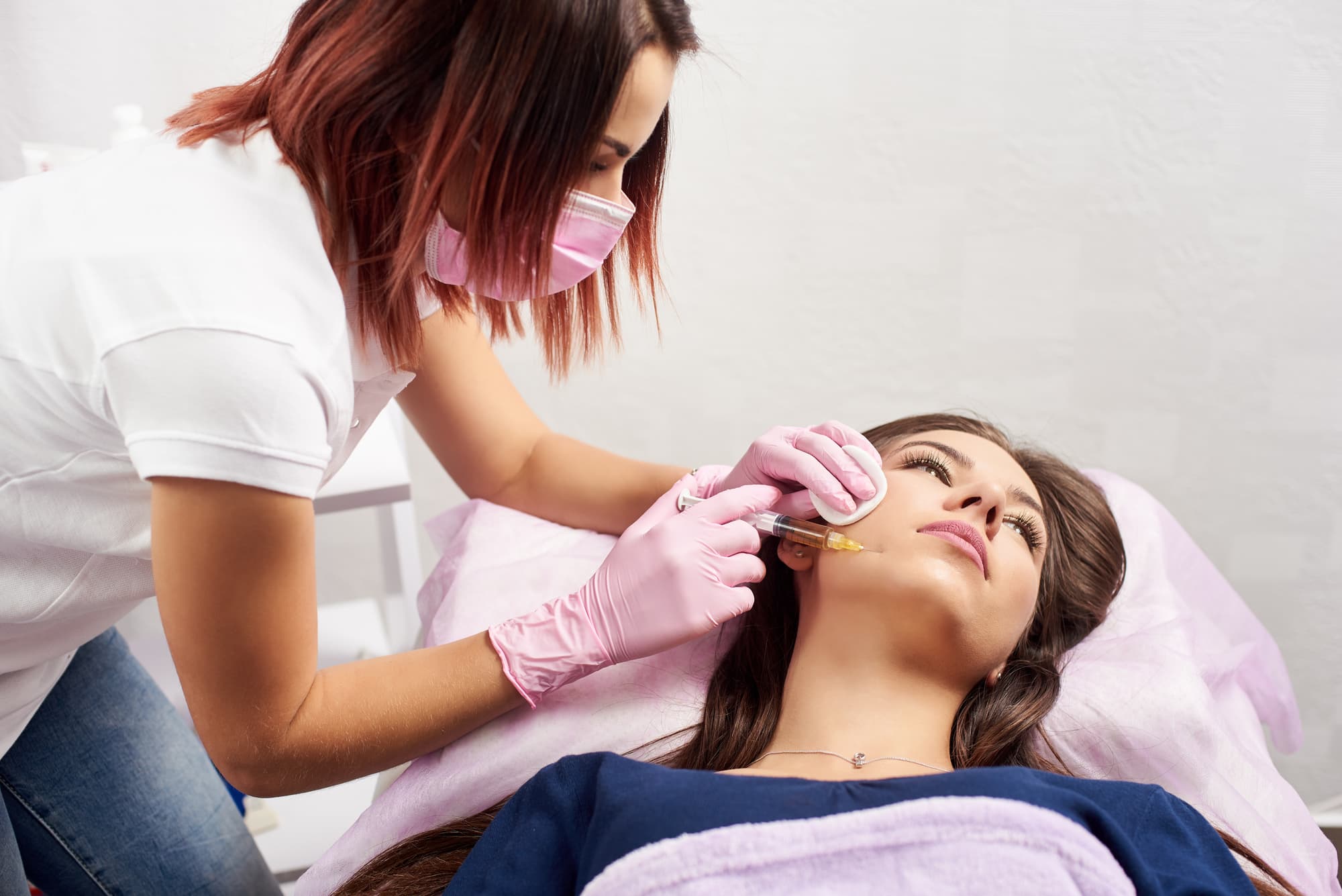 a female doctor injecting restylane dermal filler