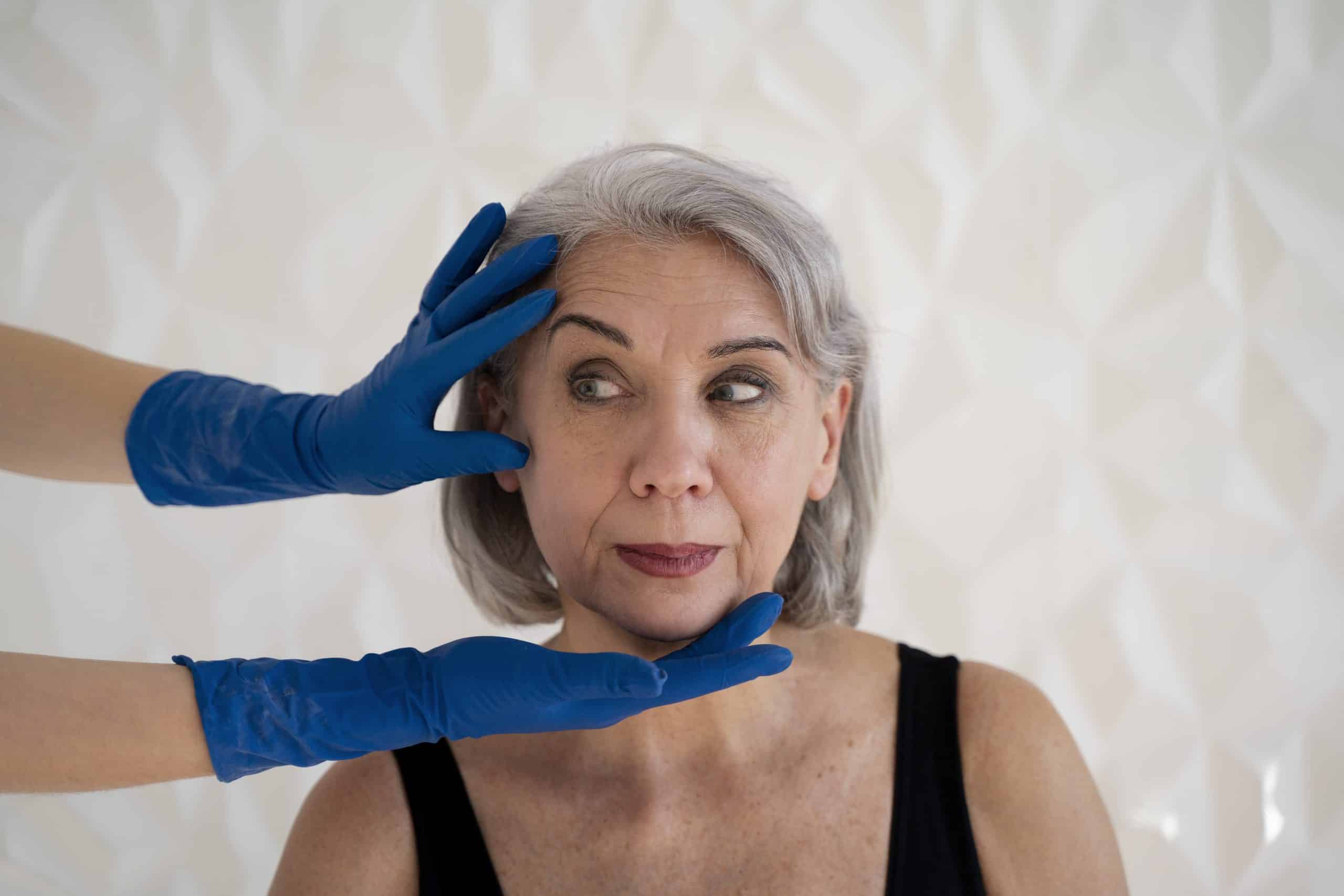 front view hands with gloves touching woman s face