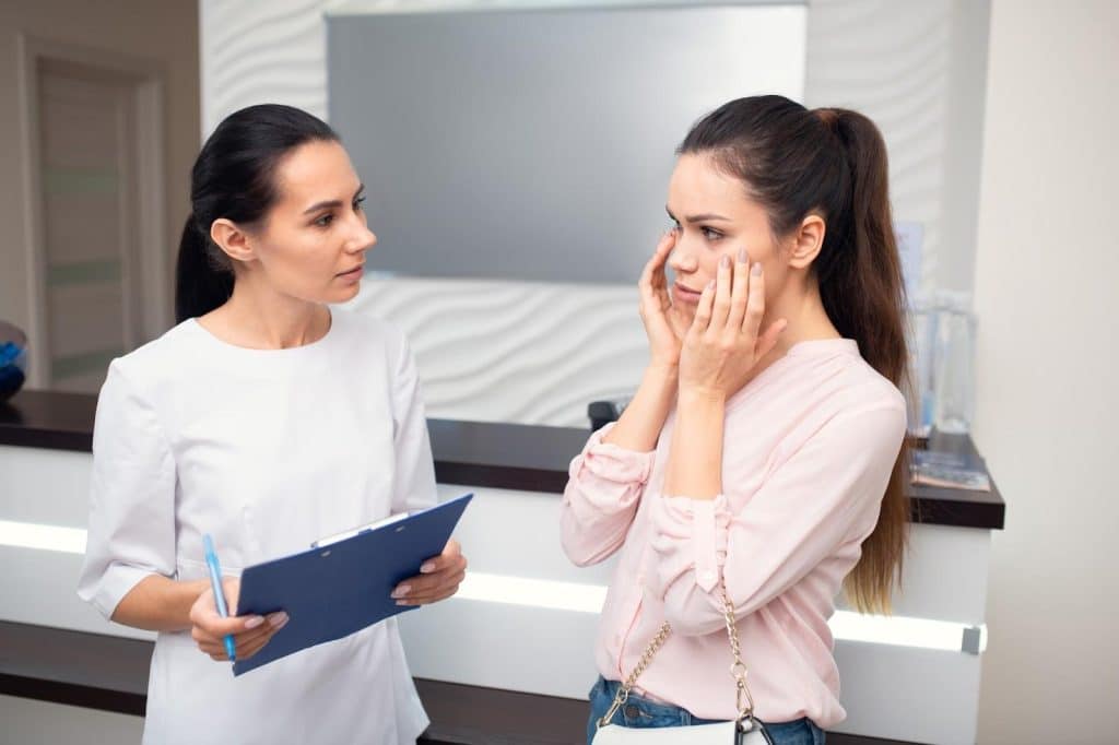 A healthcare professional consults and briefs a patient interested in Dysport treatments.