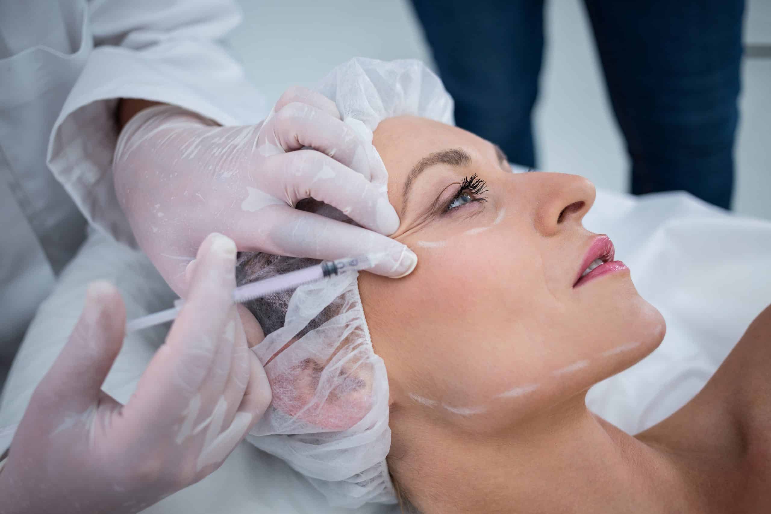 Woman receiving botox injection at clinic