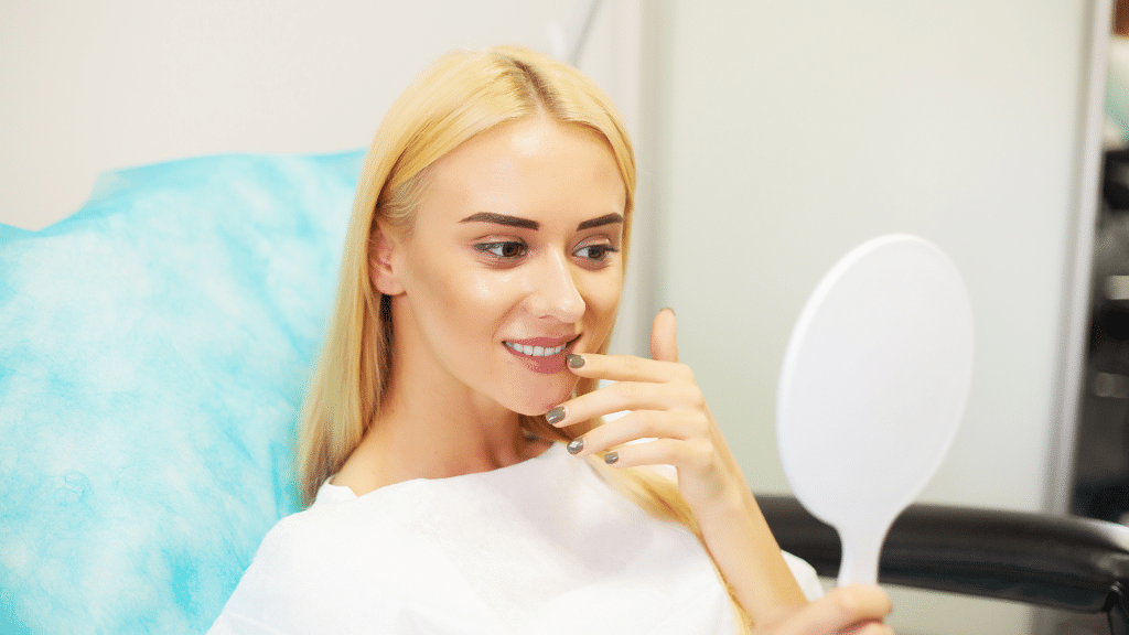 Woman looking at herself post treatment.