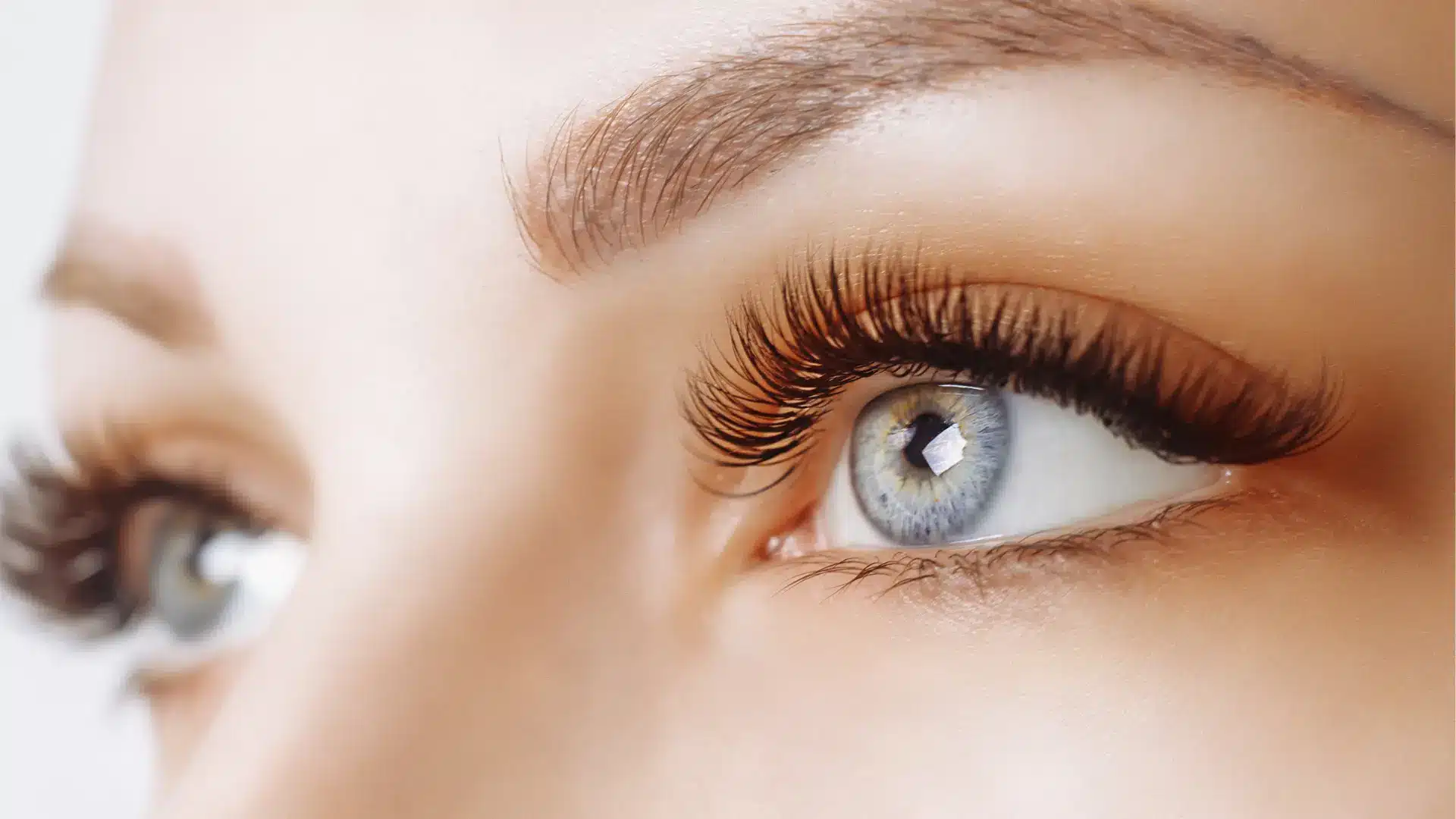 A close-up shot of an individual's fuller and darker eyelashes.